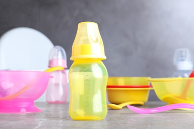 Photo of Bright child's dishware on grey table indoors