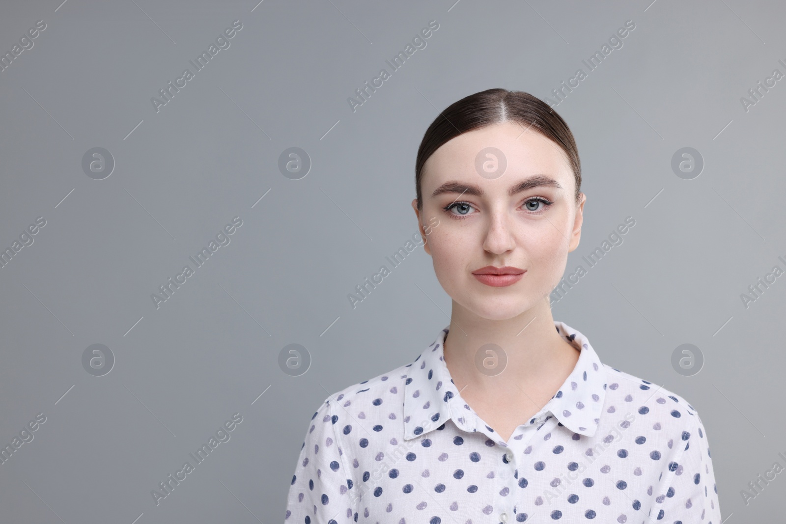 Photo of Portrait of beautiful woman on grey background, space for text