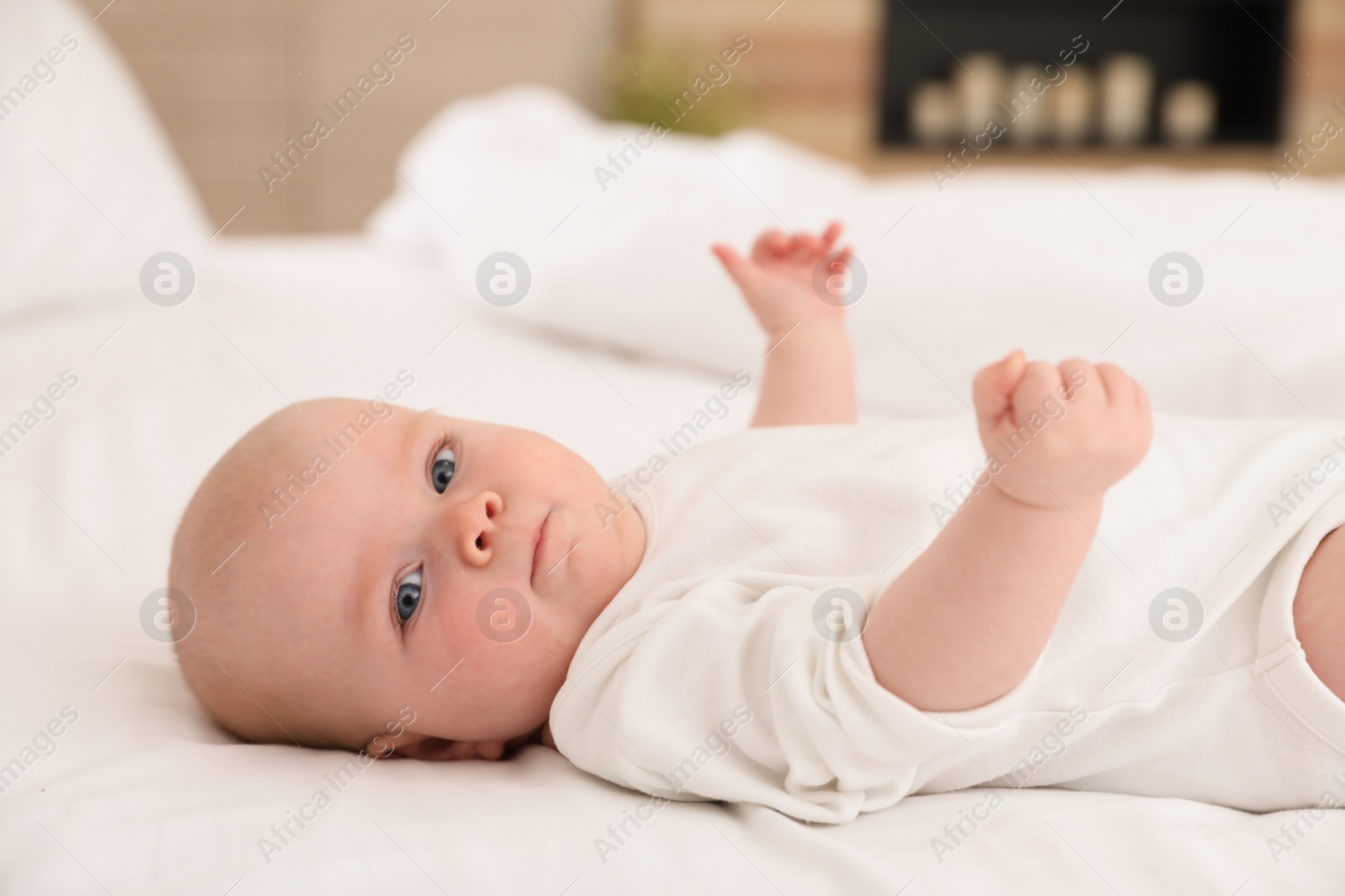 Photo of Cute little baby lying on bed at home