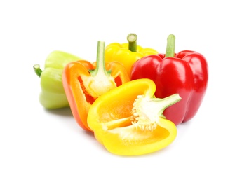 Whole and cut bell peppers on white background