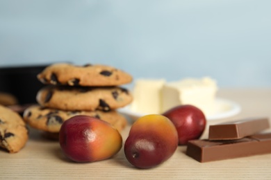 Image of Palm oil fruits and sweets on wooden table