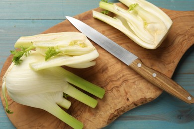Photo of Fresh raw fennel bulbs and knife on table, flat lay