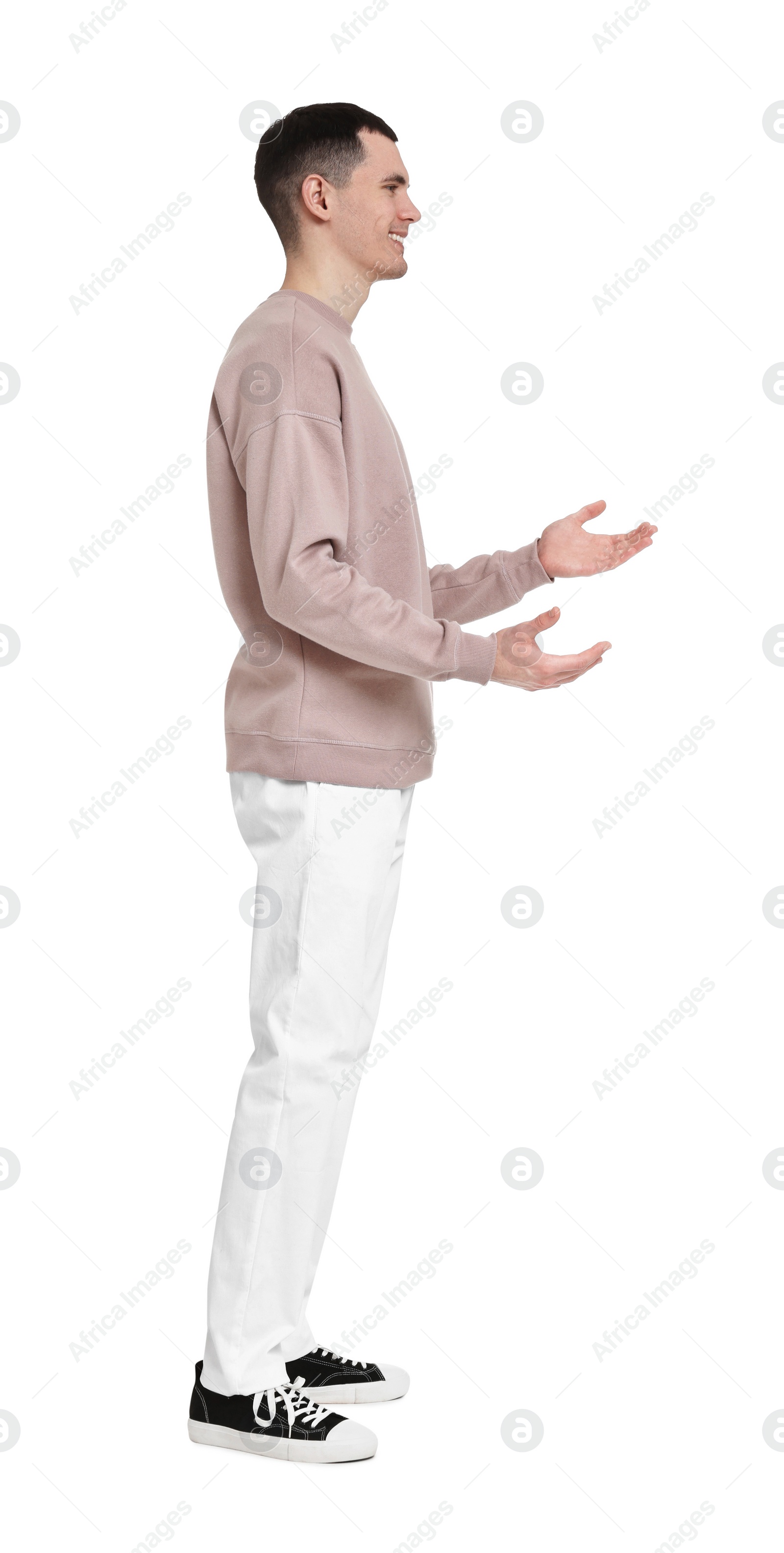 Photo of Handsome young man greeting someone on white background