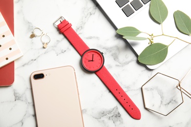 Flat lay composition with stylish wrist watch on marble background. Fashion accessory