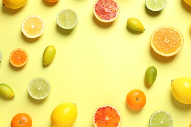 Photo of Frame made of different citrus fruits on color background, flat lay. Space for text