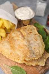 Photo of Delicious fish and chips with mangold on table, closeup