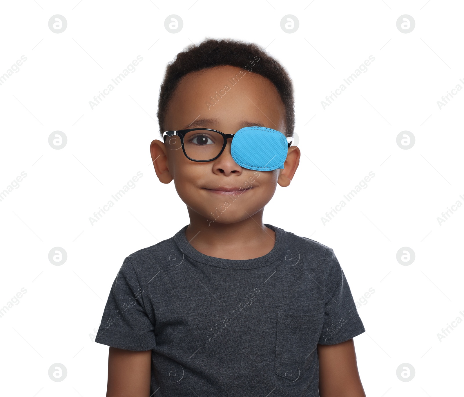 Photo of African American boy with eye patch on glasses against white background. Strabismus treatment