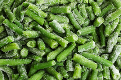 Photo of Frozen green beans as background, top view. Vegetable preservation