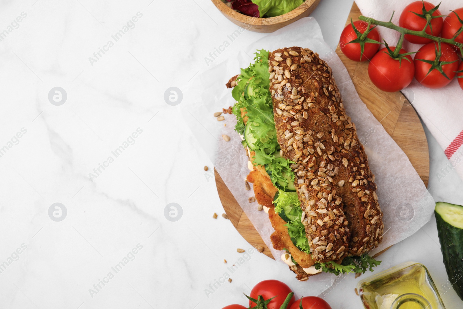 Photo of Delicious sandwich with schnitzel on white table, flat lay. Space for text