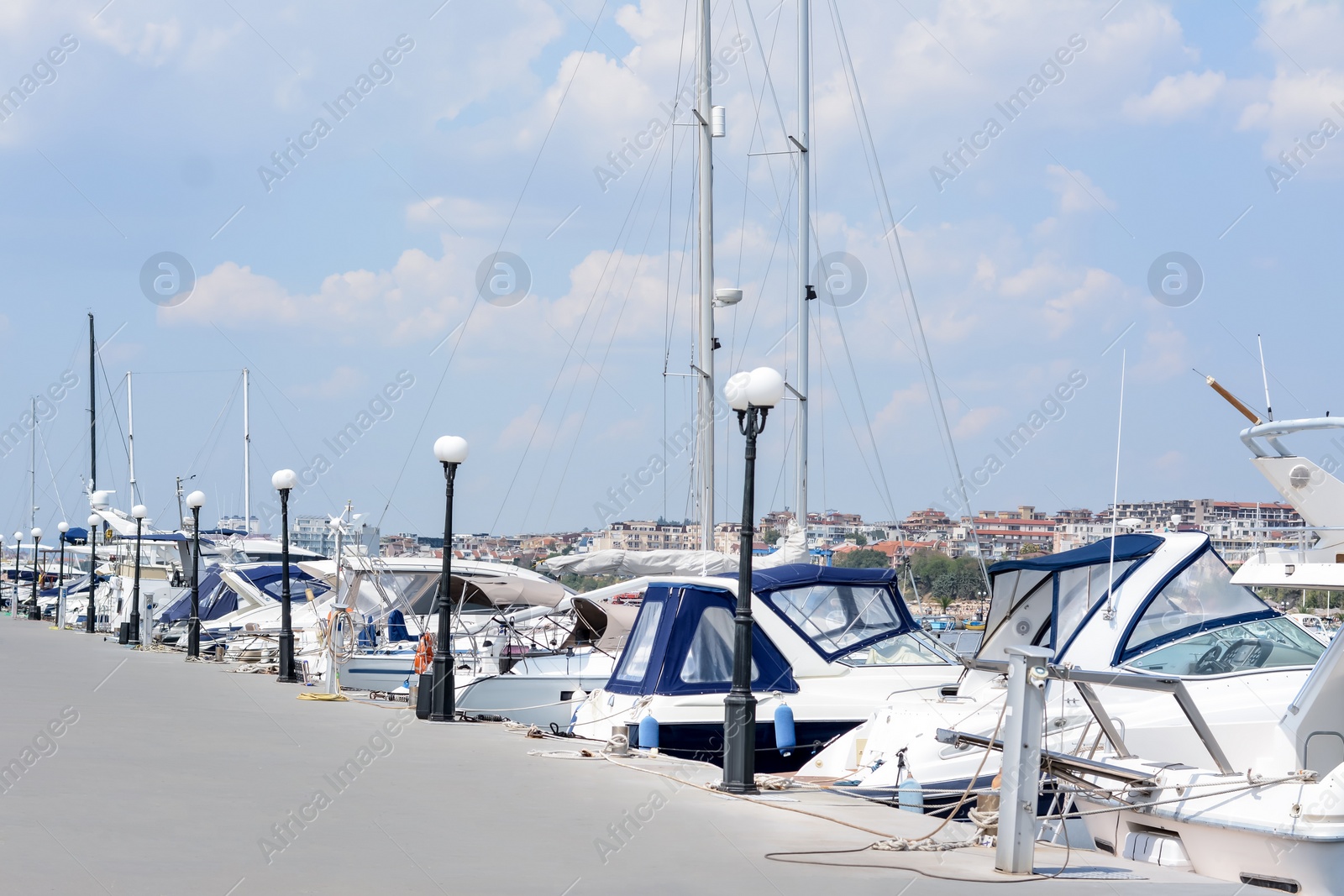 Photo of Beautiful view of city pier with moored boats on sunny day