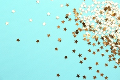 Photo of Confetti stars on light blue background, flat lay. Christmas celebration