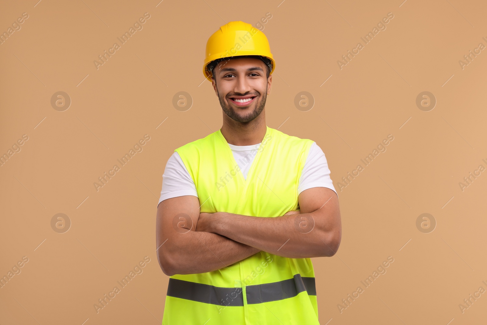 Photo of Engineer in hard hat on beige background