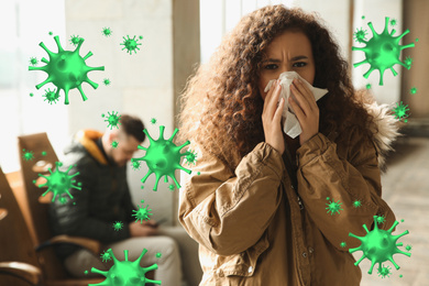 Image of Young African-American woman sneezing indoors. Dangerous virus