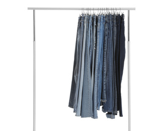 Photo of Rack with different jeans isolated on white