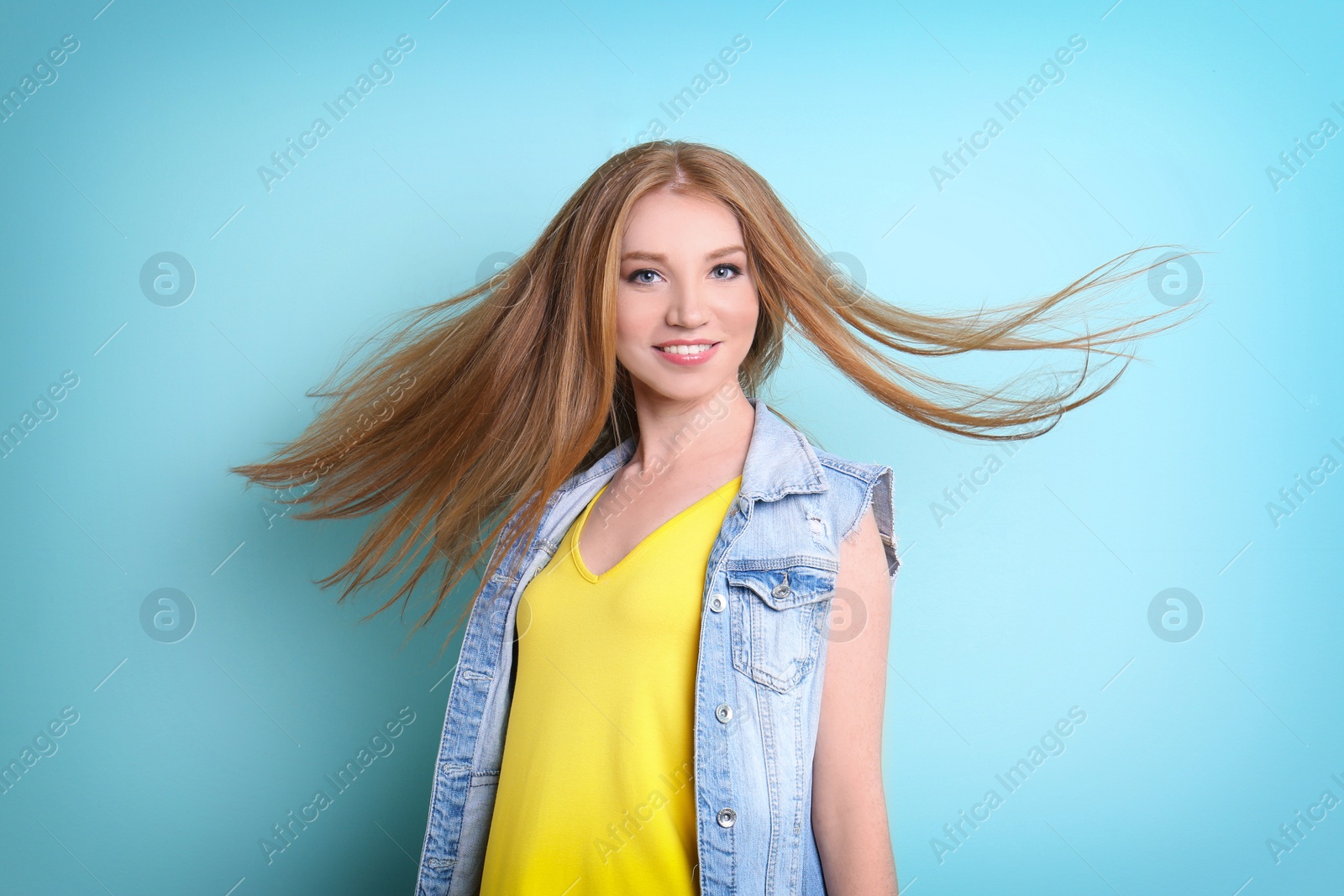 Photo of Portrait of young model with beautiful  hair on color background