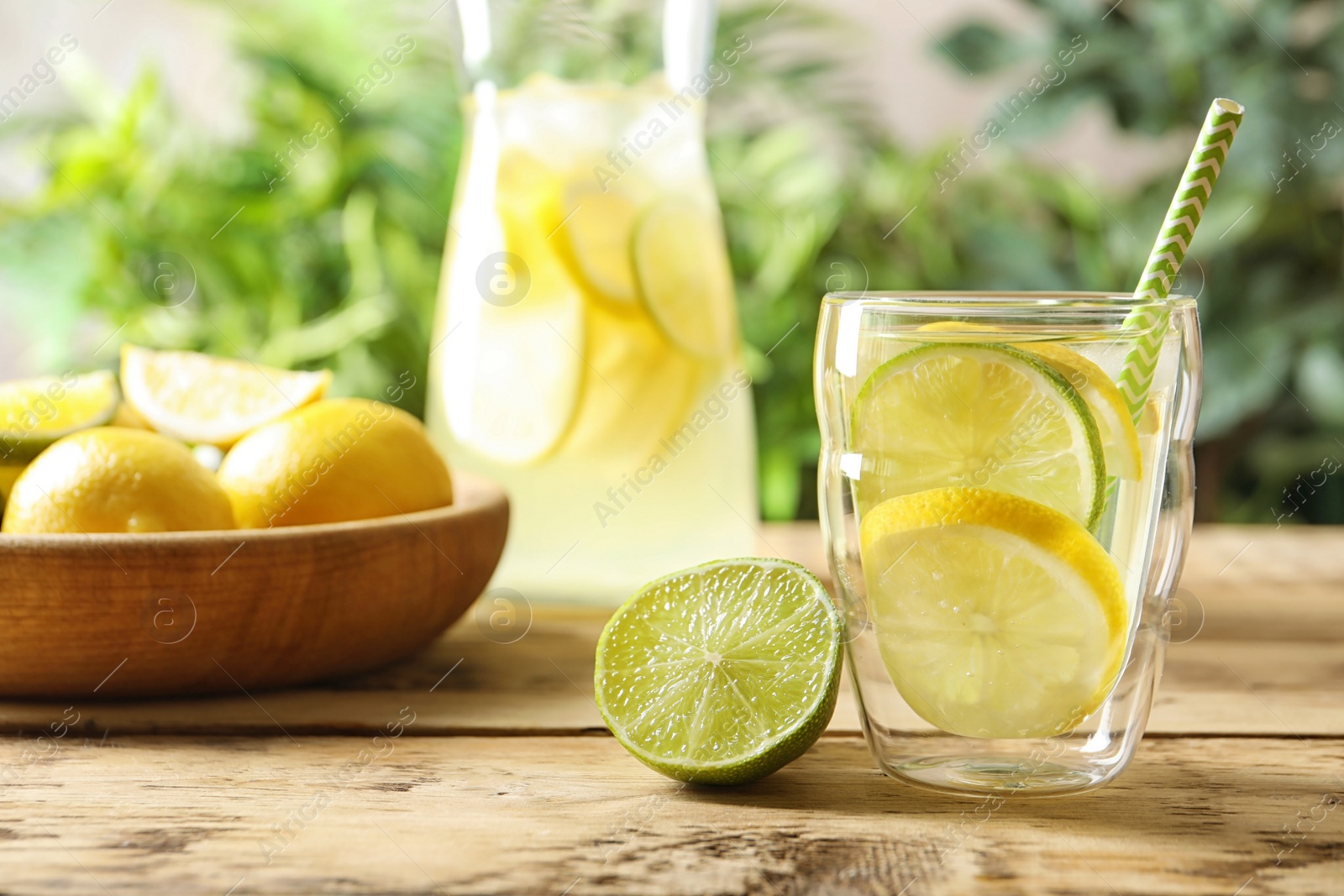 Photo of Natural lemonade with lime in glass on table