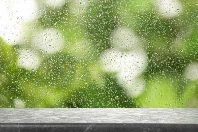 Grey marble table near window on rainy day