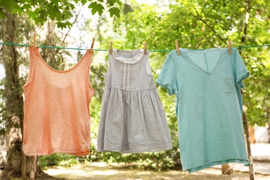 Photo of Laundry line with clothes outdoors on sunny day