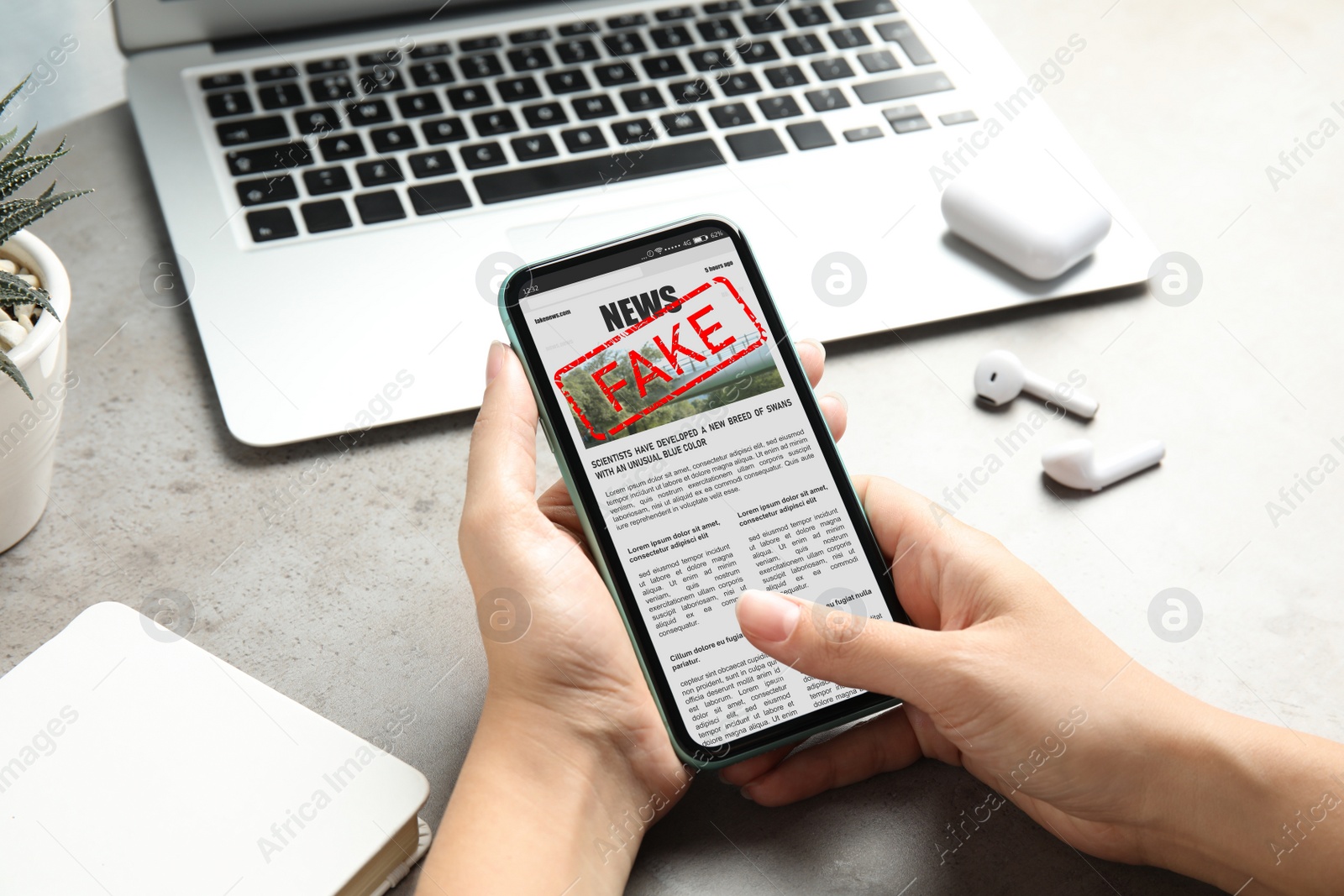 Image of Fake information. Woman using mobile phone to read news at table, closeup