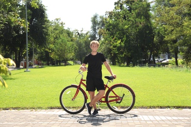 Photo of Attractive man with bike outdoors on sunny day