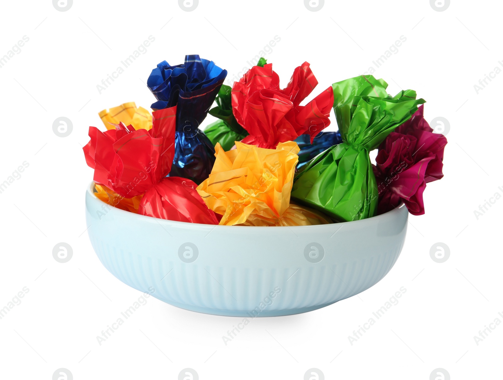 Photo of Bowl with candies in colorful wrappers isolated on white