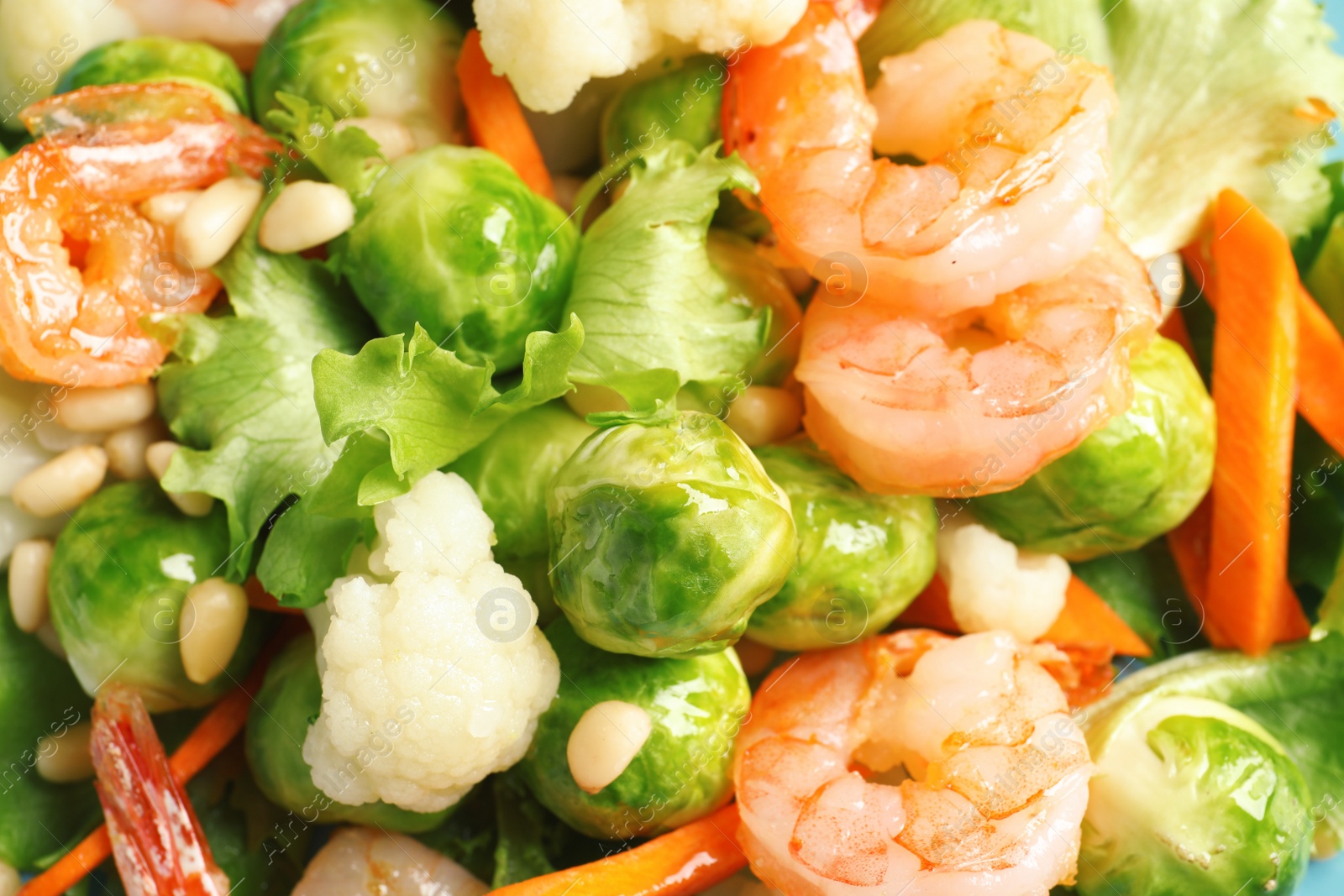 Photo of Salad with Brussels sprouts and shrimps as background, closeup