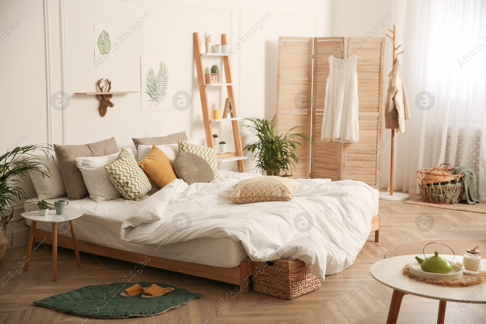 Photo of Modern bedroom with beautiful fresh house plants