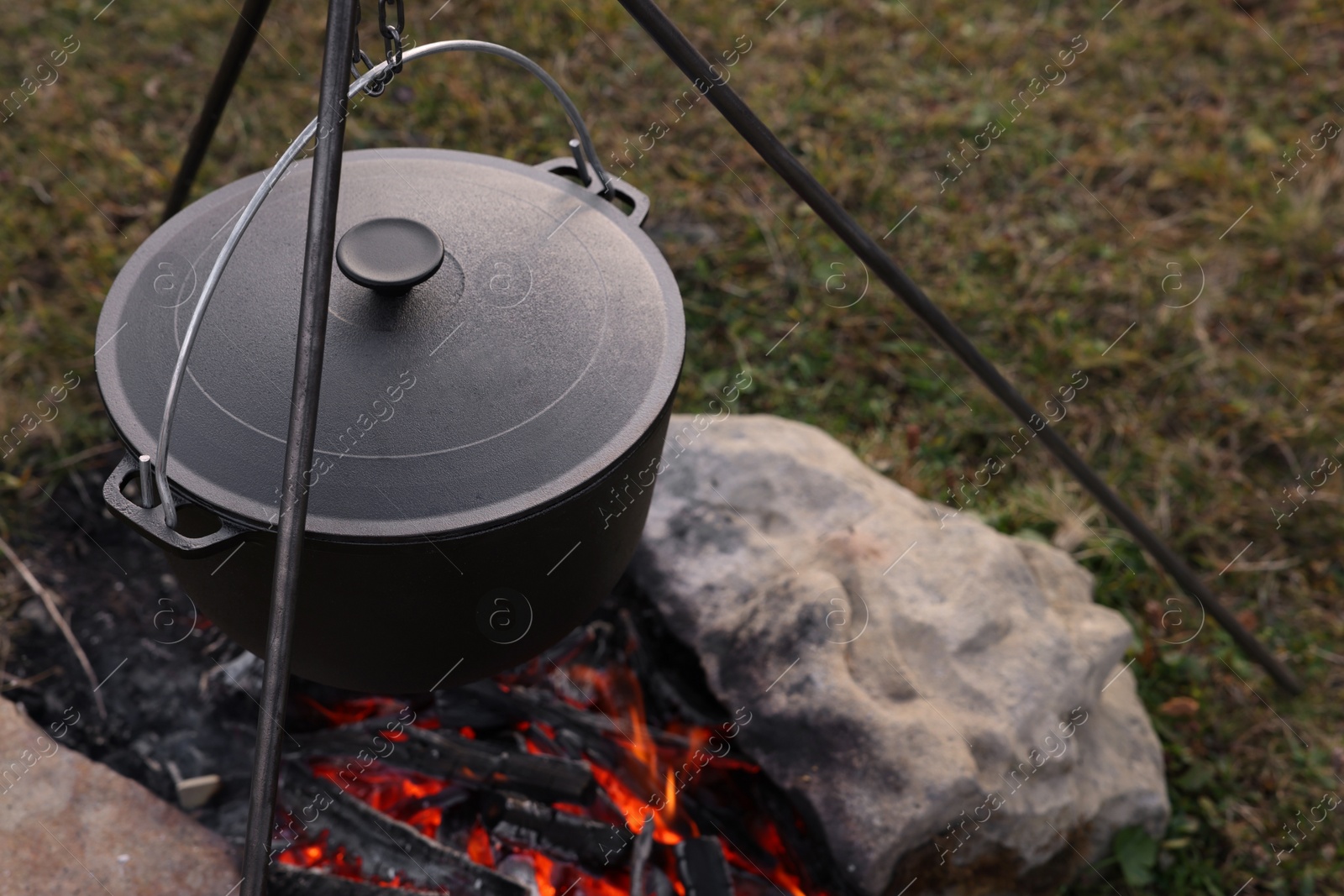 Photo of Cooking food on campfire outdoors. Camping season