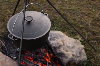 Photo of Cooking food on campfire outdoors. Camping season
