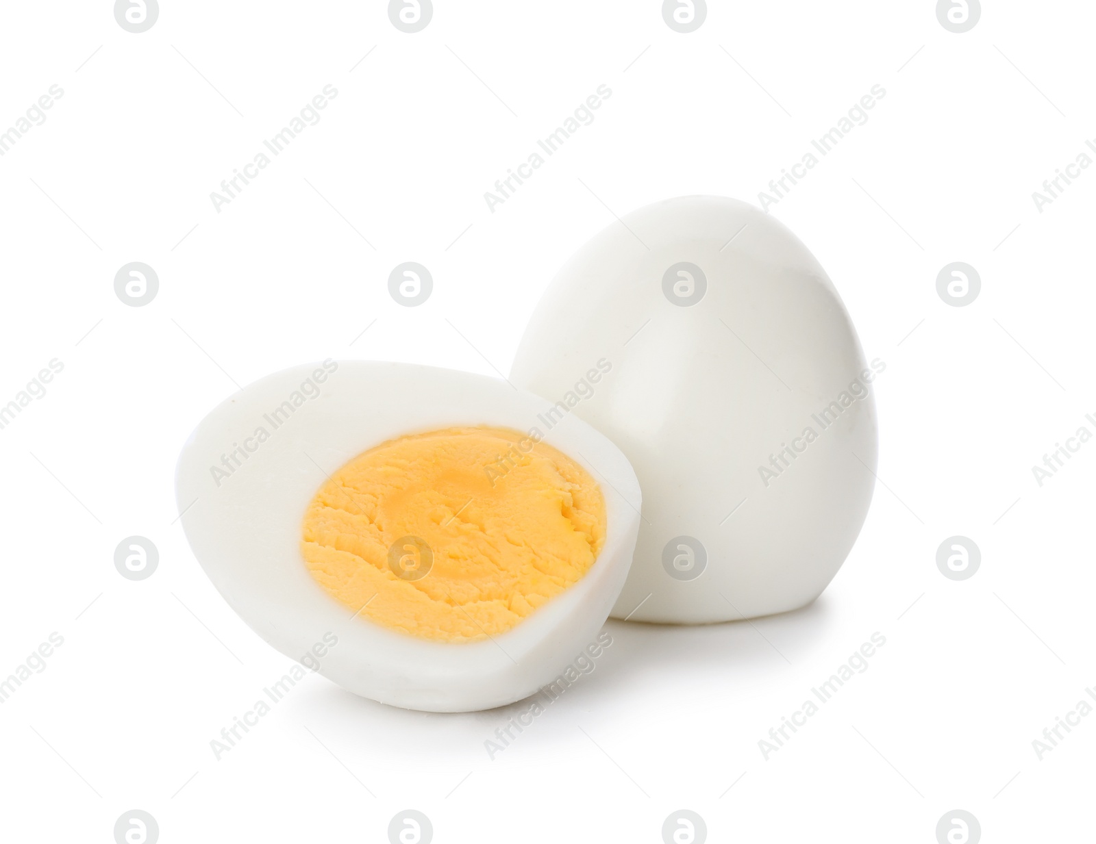 Photo of Sliced and whole hard boiled eggs on white background