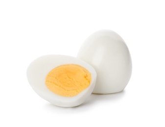 Sliced and whole hard boiled eggs on white background