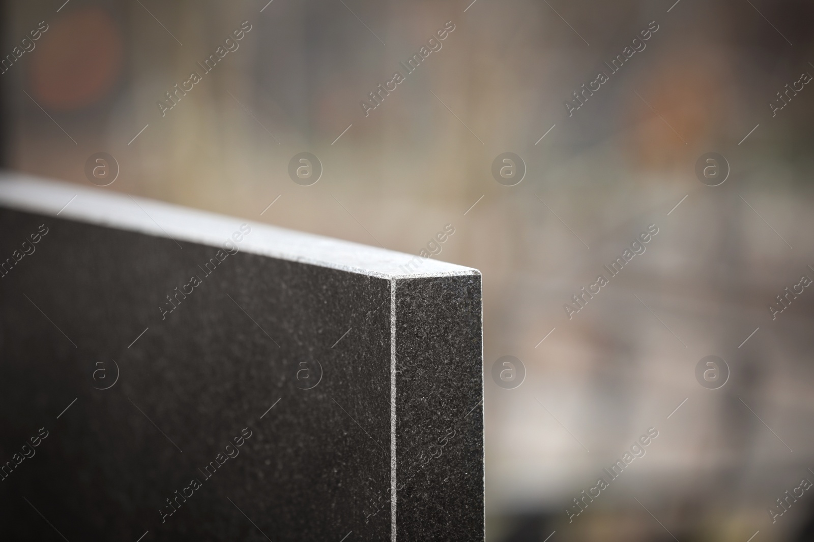 Photo of Black granite tombstone outdoors, closeup. Funeral ceremony