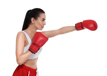 Beautiful woman in boxing gloves training on white background
