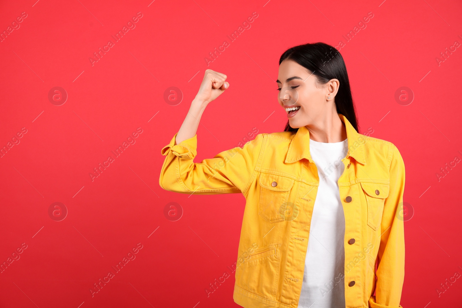 Photo of Strong woman as symbol of girl power on red background, space for text. 8 March concept