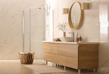 Photo of Modern bathroom interior with stylish mirror, vessel sink and glass shower stall