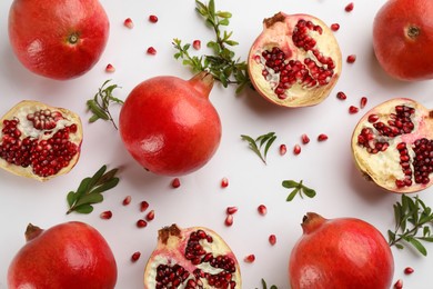 Photo of Flat lay composition with ripe pomegranates on white background