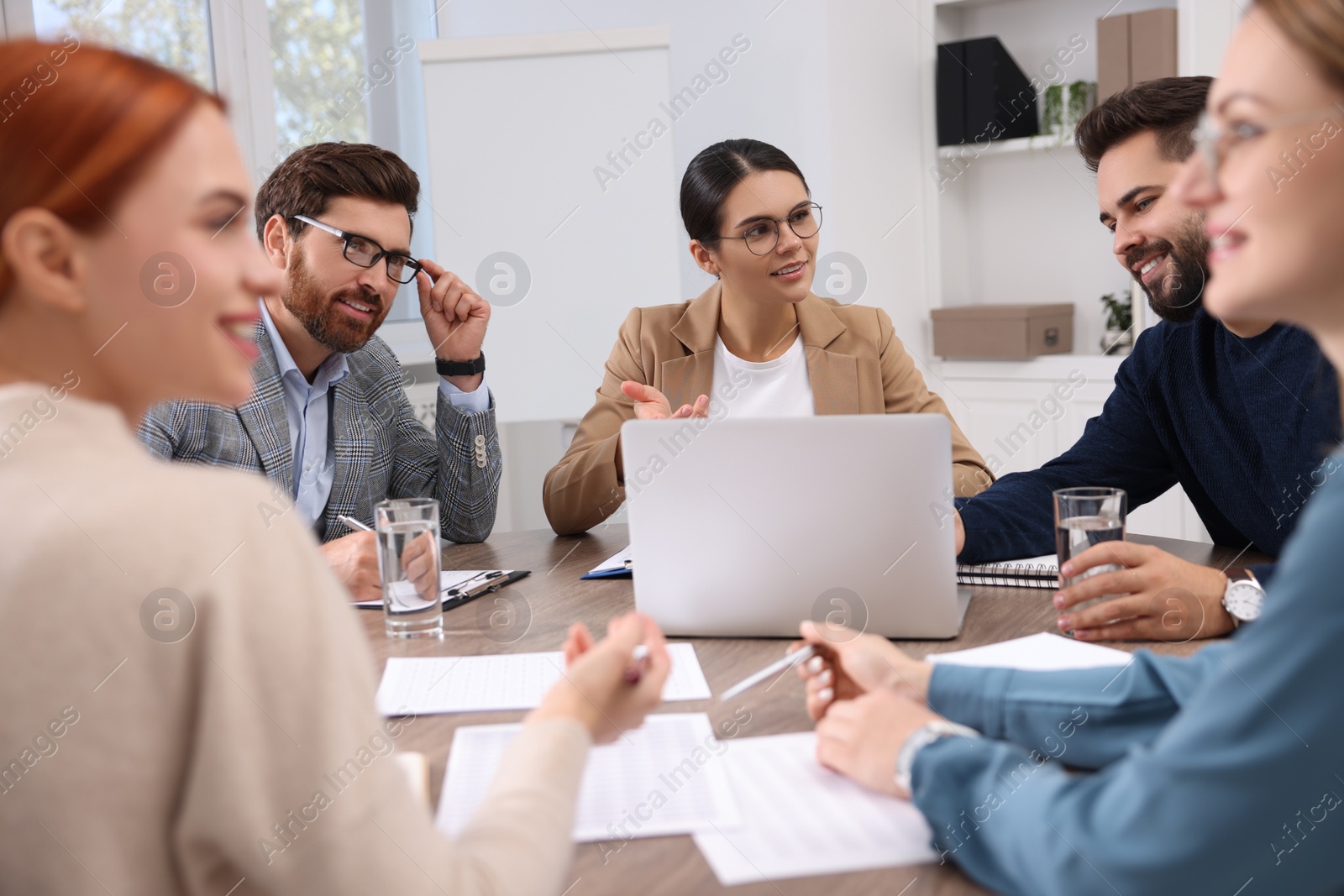 Photo of Team of employees working together in office