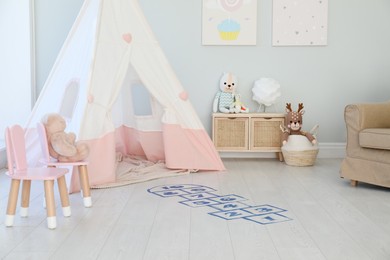 Beautiful child's room with blue hopscotch floor sticker
