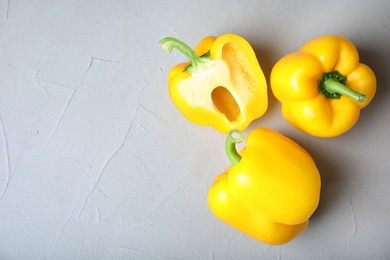 Photo of Raw ripe paprika peppers on grey background, top view