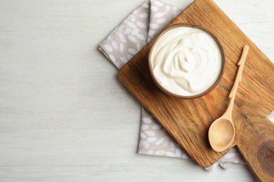 Photo of Flat lay composition with creamy yogurt and space for text on light background