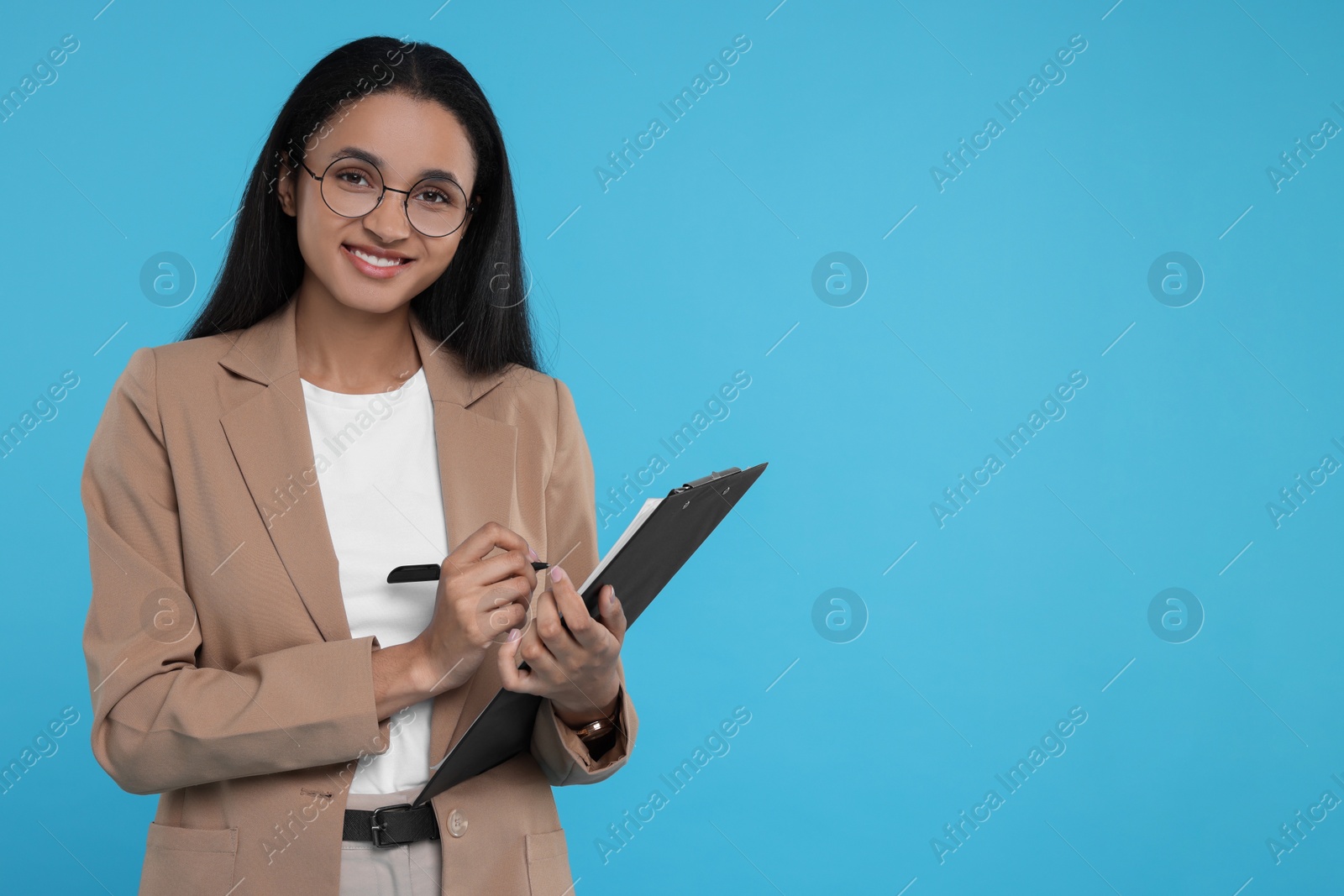 Photo of Beautiful secretary with clipboard and pen on light blue background, space for text