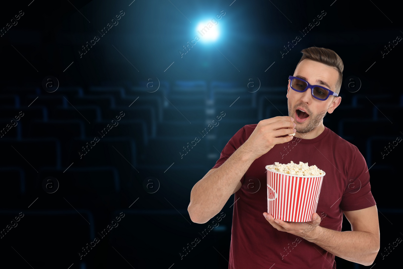 Image of Man with 3D glasses and popcorn in cinema, space for text