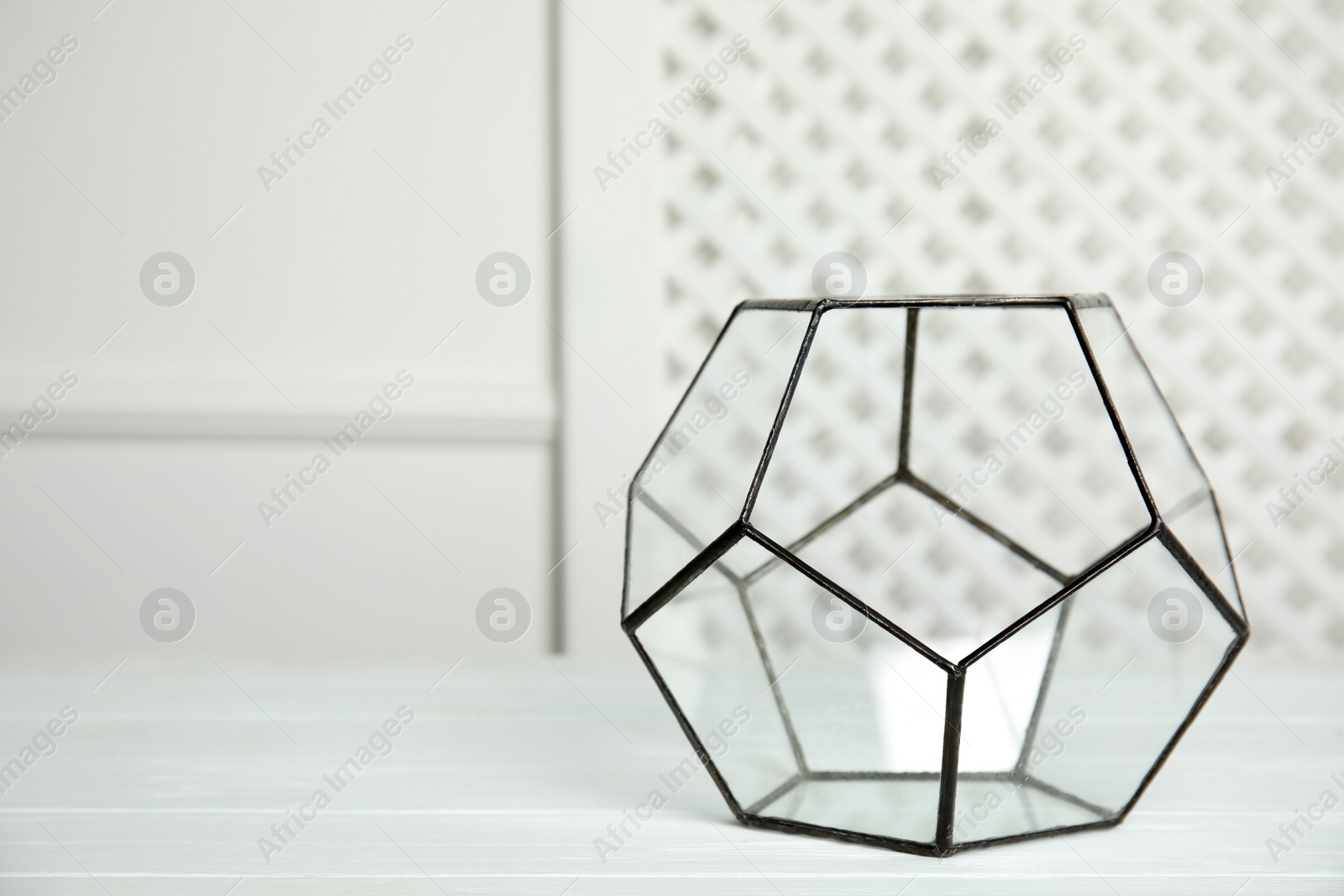 Photo of Empty glass florarium vase on white table indoors, space for text