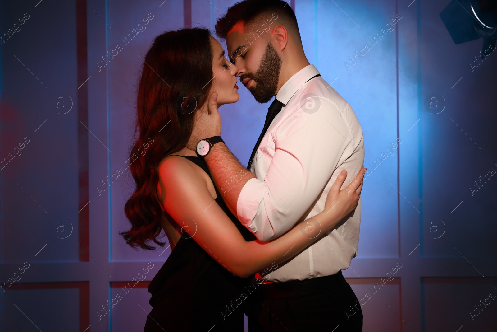 Photo of Handsome bearded man with sexy lady indoors. Color toned