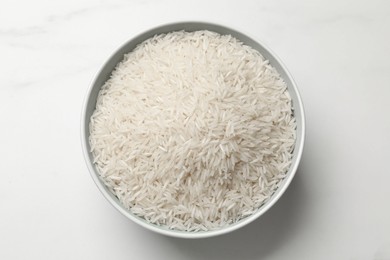 Photo of Raw basmati rice in bowl on white table, top view