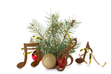 Composition with Christmas tree branch, decor and wooden music notes on white background