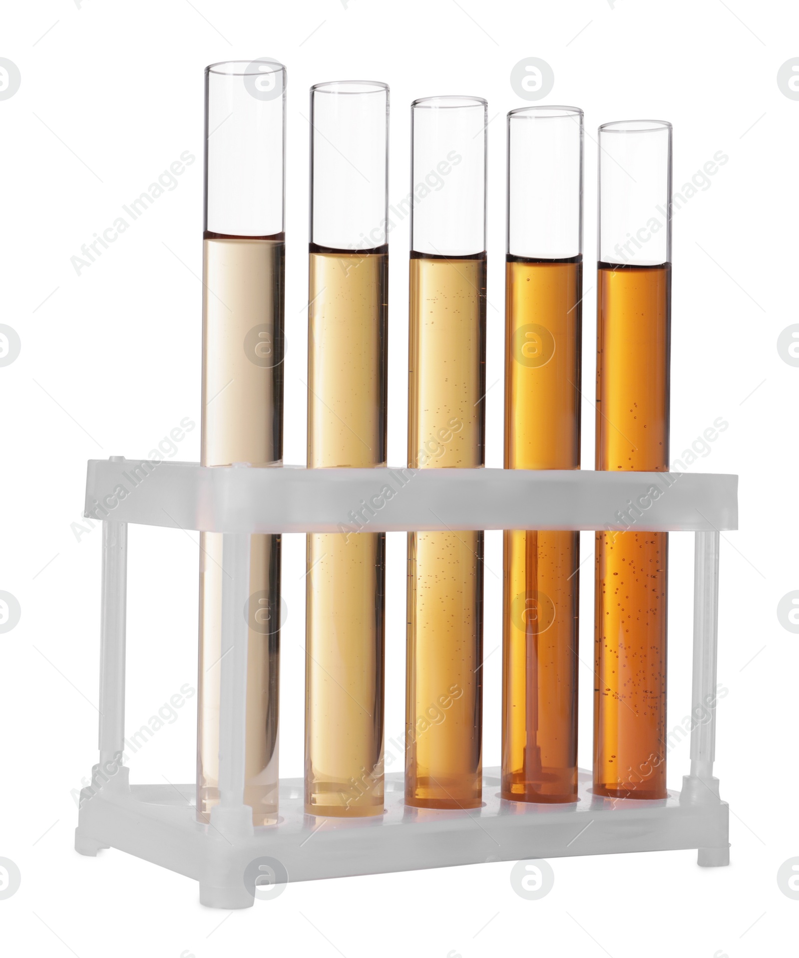 Photo of Test tubes with brown liquid in stand on white background