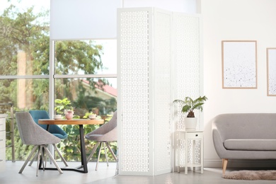 Photo of Modern folding screen in stylish room interior