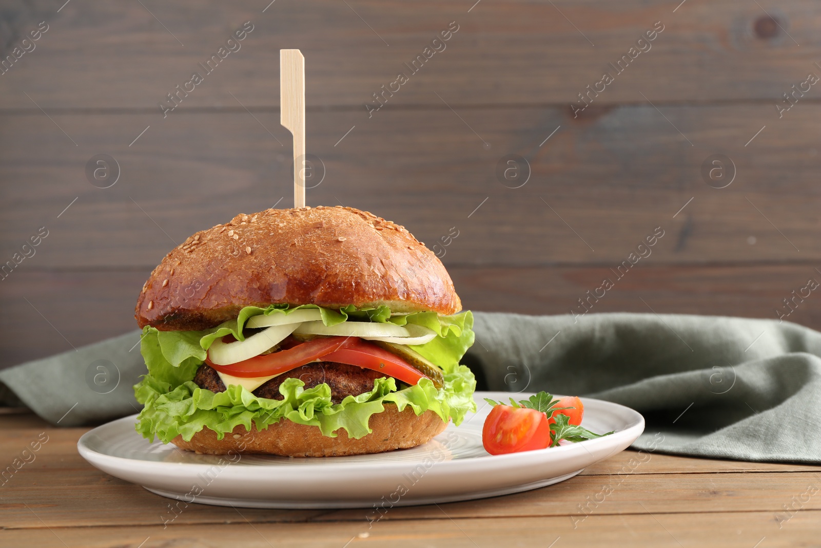 Photo of Delicious vegetarian burger served on wooden table