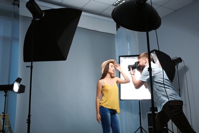 Beautiful model posing for professional photographer in studio